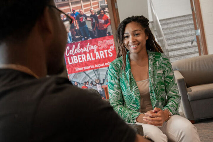 Liberal Arts students talk in lounge of Cavanaugh Hall.